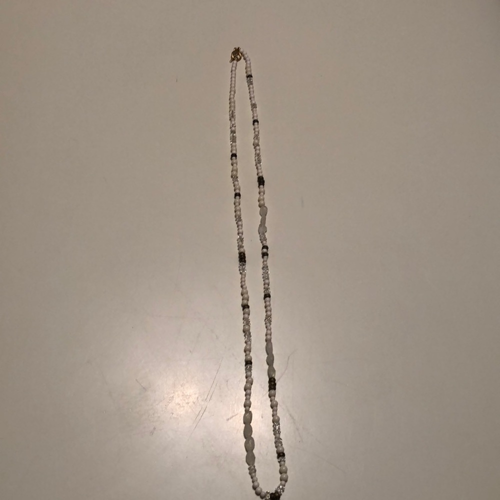 White, gold and clear bead long necklace.